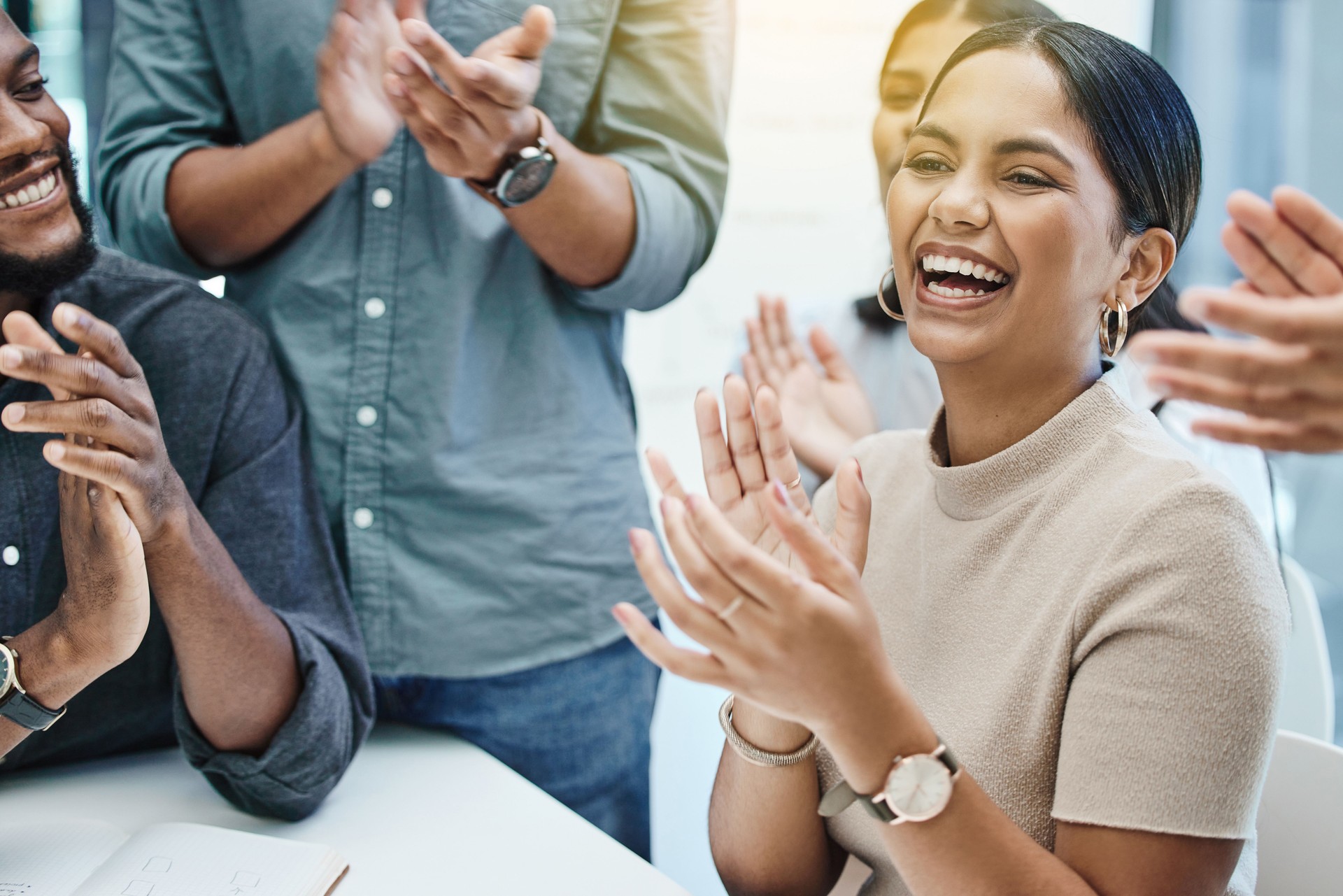 Shot of a group of business people applauding a team member